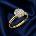 A yellow gold halo ring with a cluster of round-cut diamonds, displayed on a dark blue satin fabric background. A faint watermark for 'PO MARTIN'S Jewelry Shop Goldsmith' is visible in the center.
