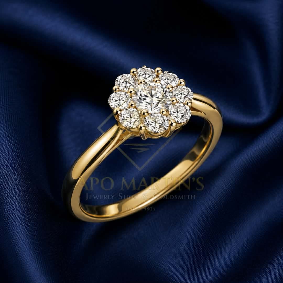 A yellow gold halo ring with a cluster of round-cut diamonds, displayed on a dark blue satin fabric background. A faint watermark for 'PO MARTIN'S Jewelry Shop Goldsmith' is visible in the center.